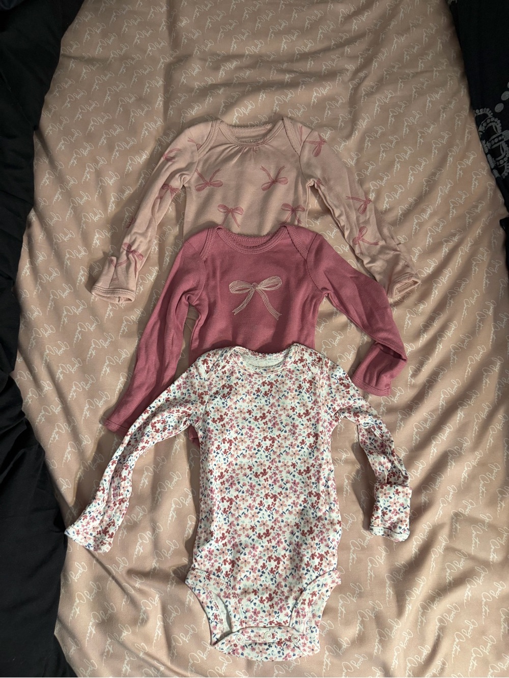 Long sleeve 3 pack multi colored onsies. New without tags and size 0-3 months